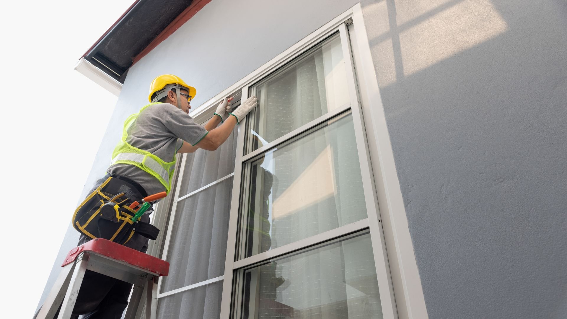 Maintenance technician repairing a window