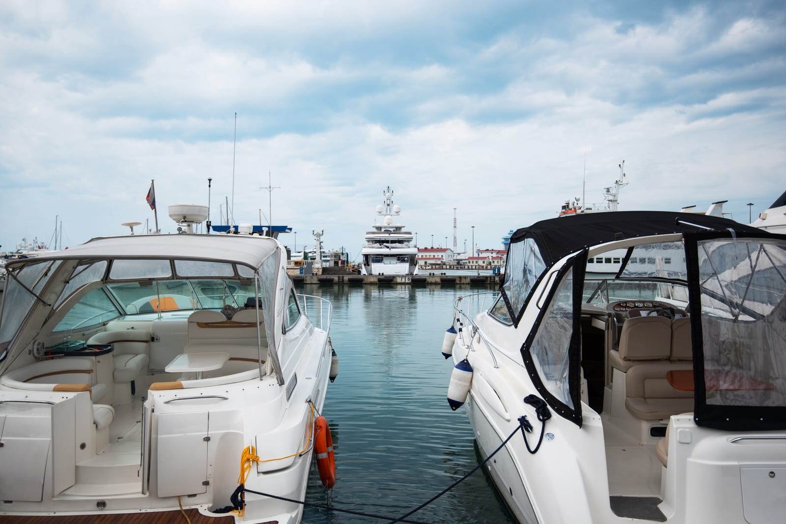 Powerboats moored in a marina under overcast skies