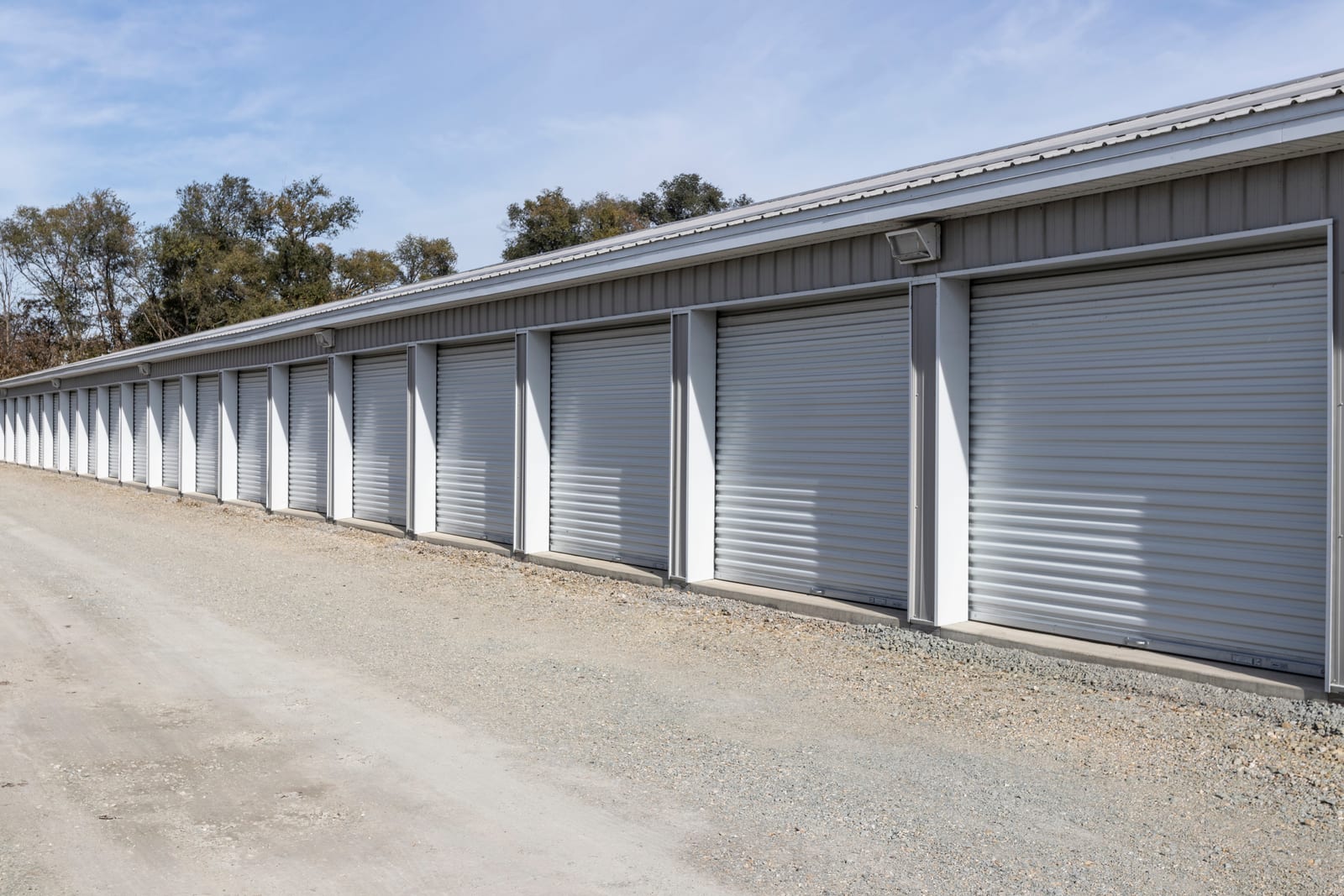 Drive-up storage units running alongside a gravel access drive
