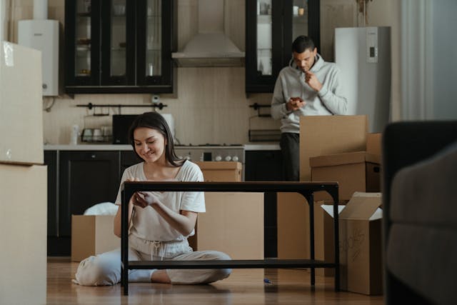 pexels-cottonbro-4554438 two people sitting in kitchen surrounded by moving boxes
